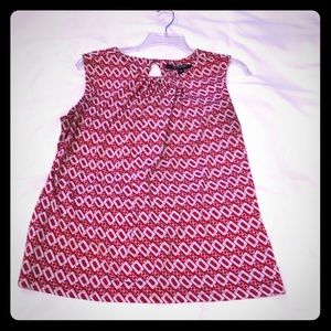 Red and white or black and white sleeveless top.